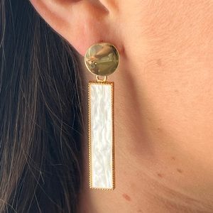 White pearl color drop earrings with gold metal base.